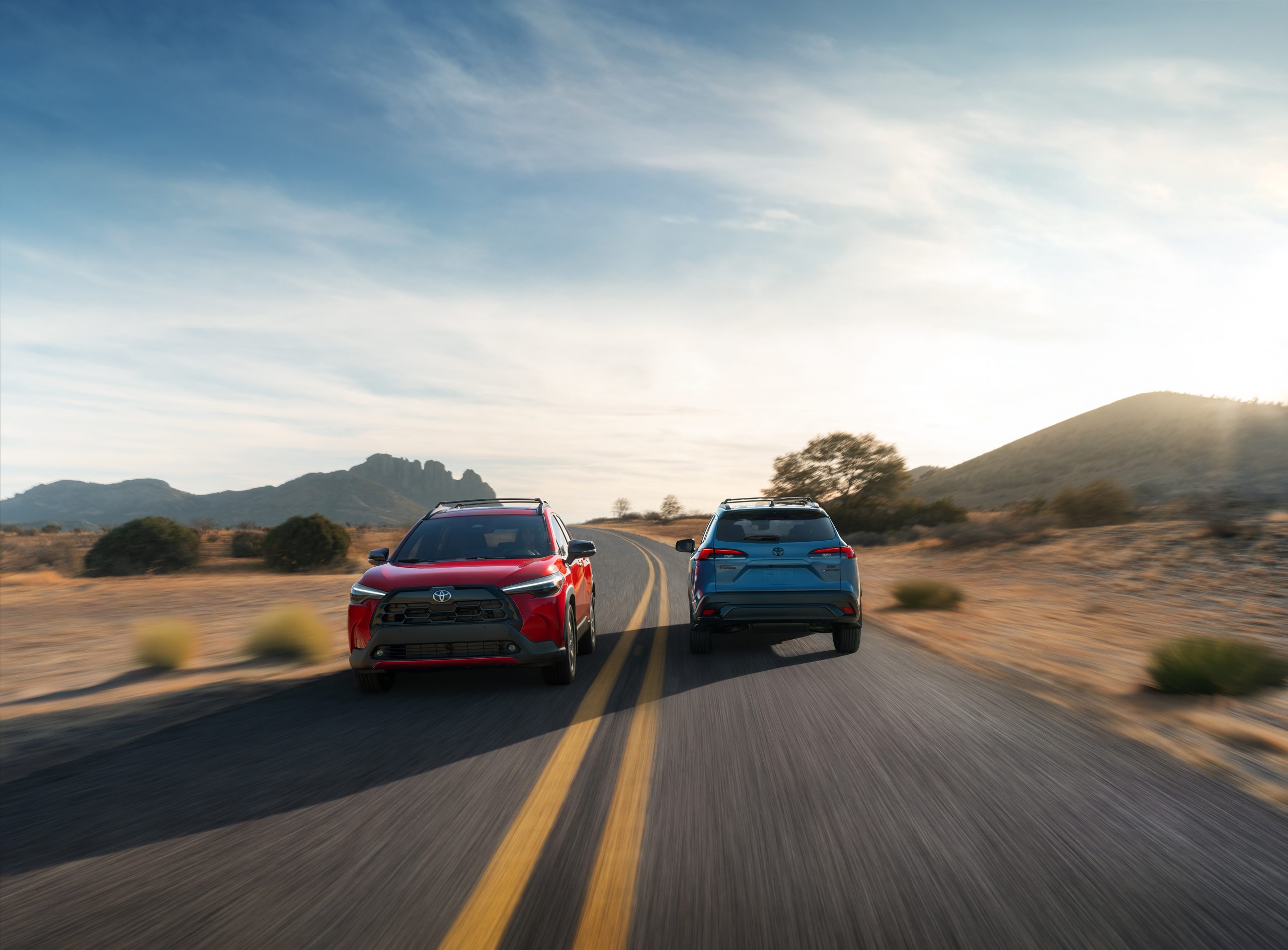 2026 Toyota Corolla Cross Gas and Hybrid driving on a road