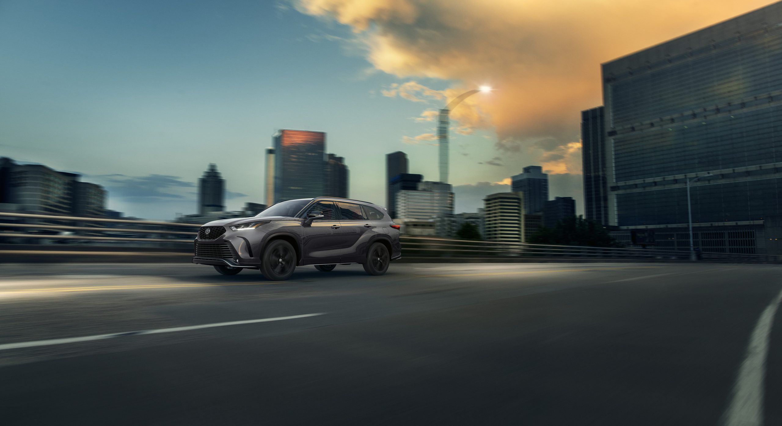 2026 Toyota Highlander driving through the city
