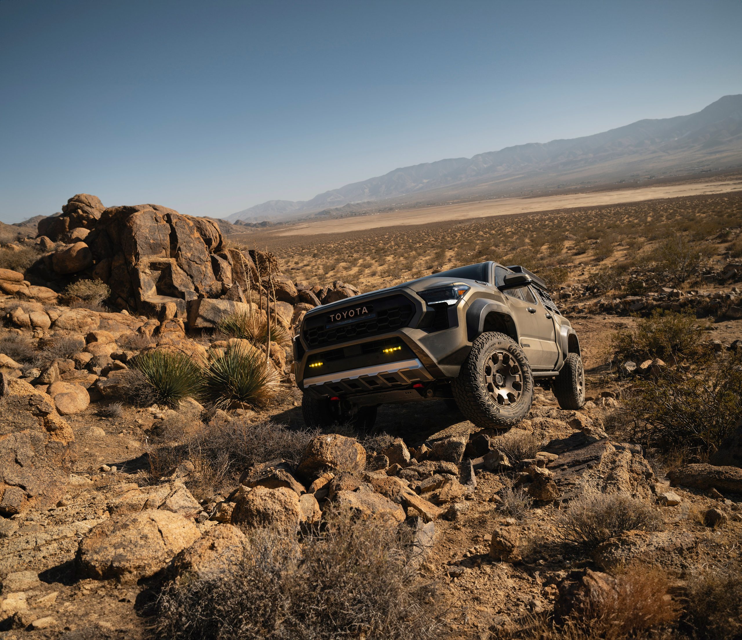 2026 Toyota Tacoma driving on rugged terrain