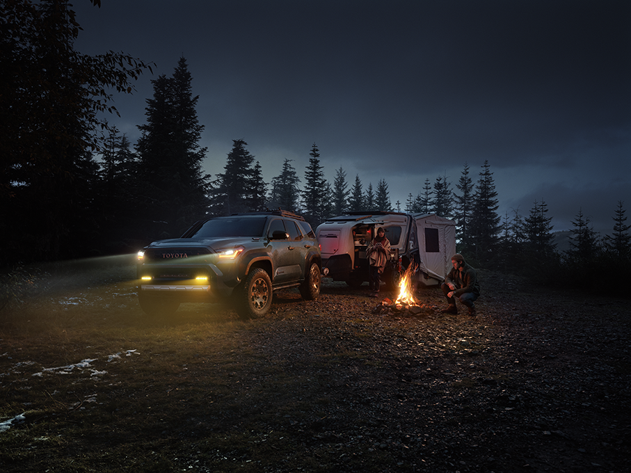 Toyota 4Runner towing a camper at night