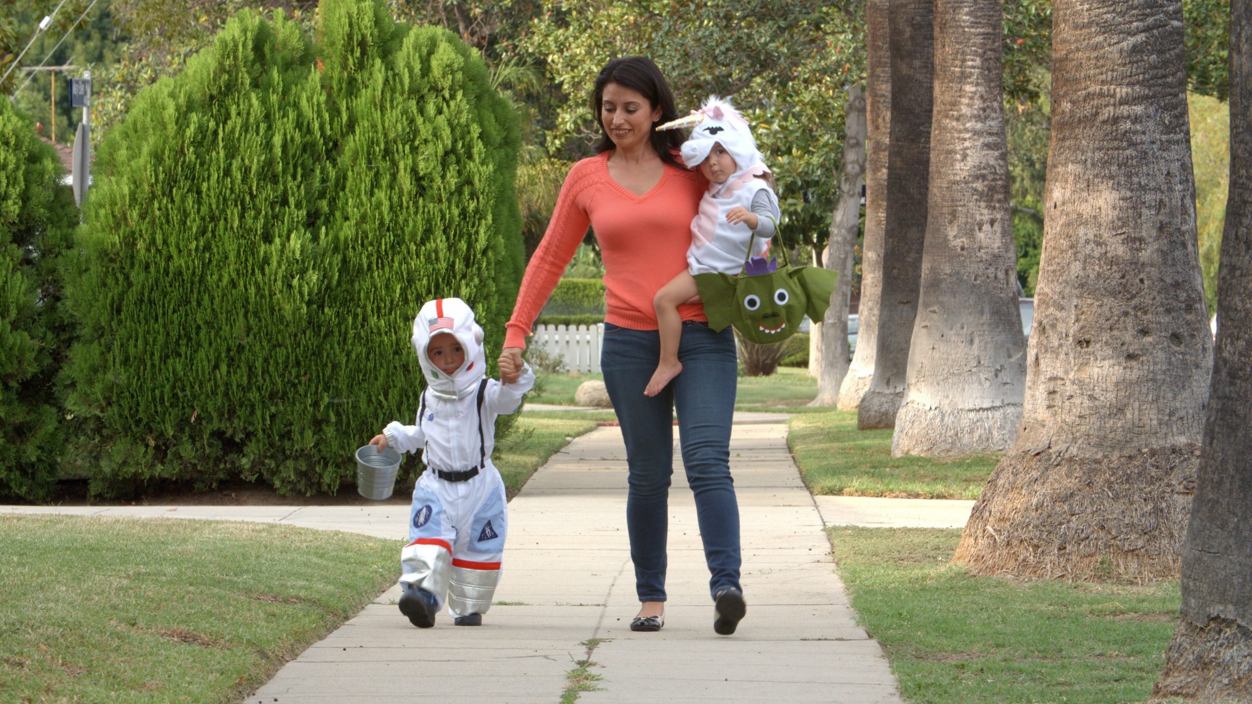 a mother with her children trick or treating
