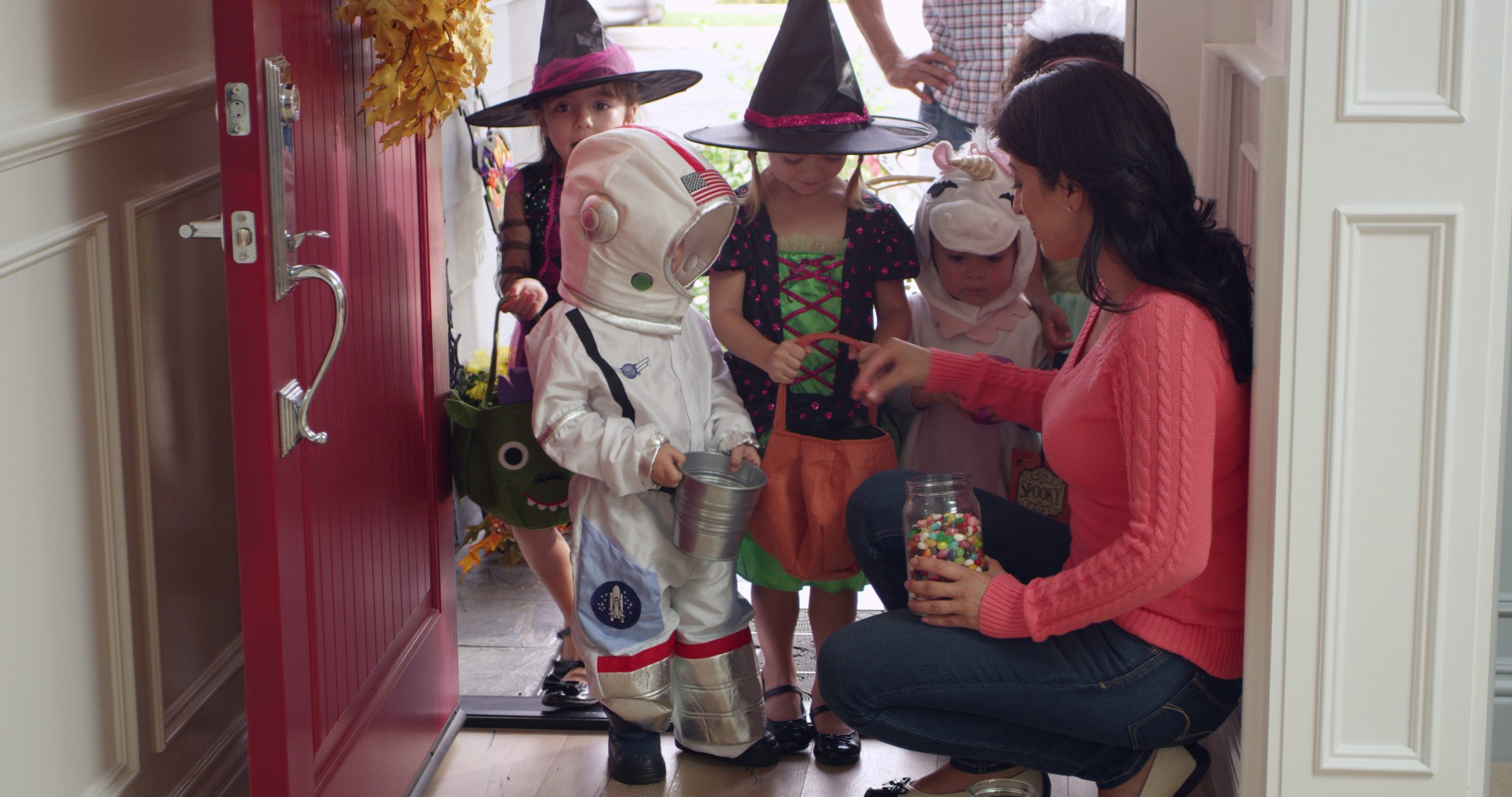 Kids standing in a door way getting candy