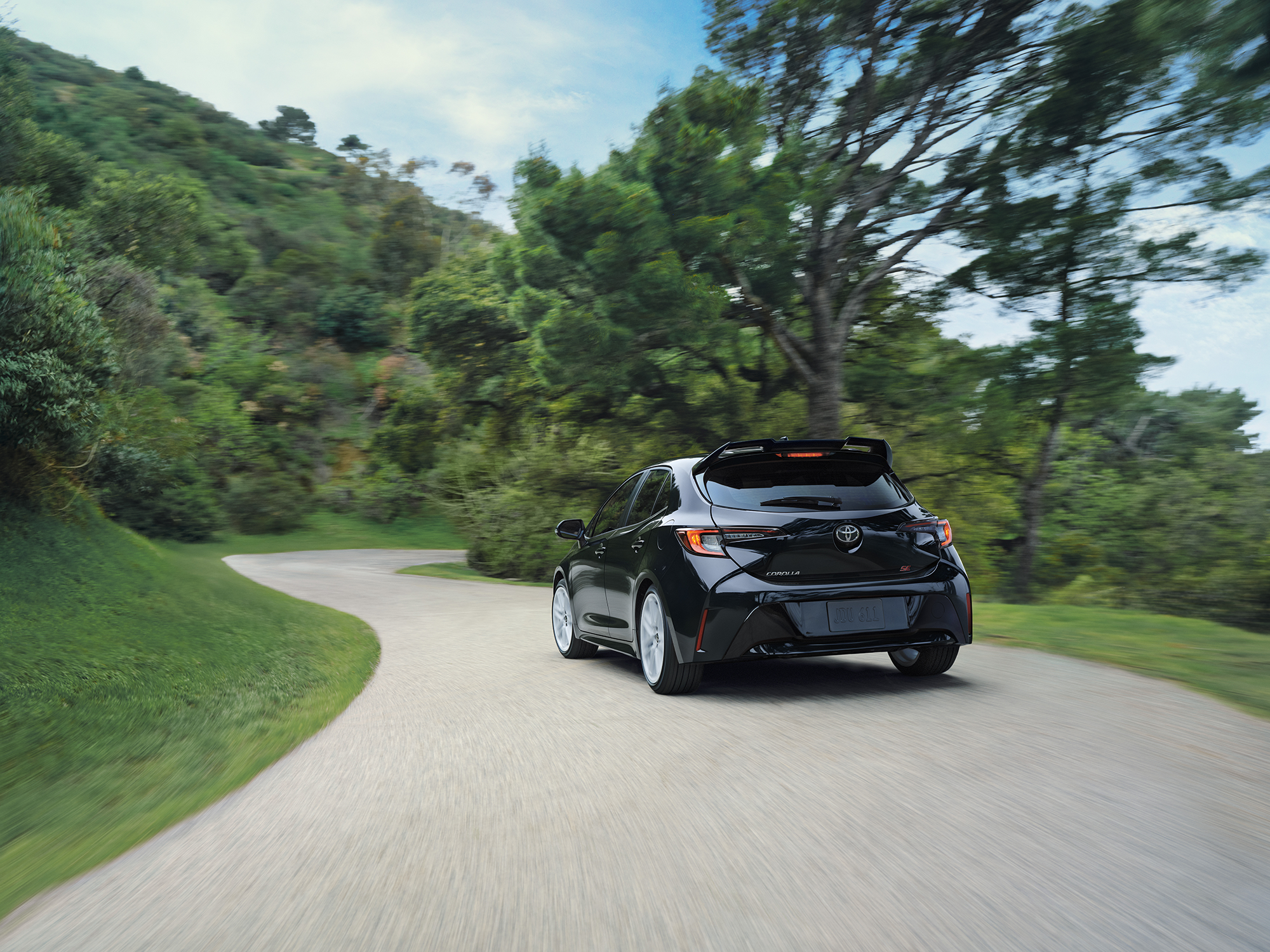 2027 Toyota Corolla Hatchback driving on a nature road